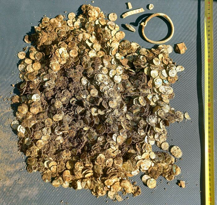 Pile of ancient gold coins and artifacts from a historic treasure discovery