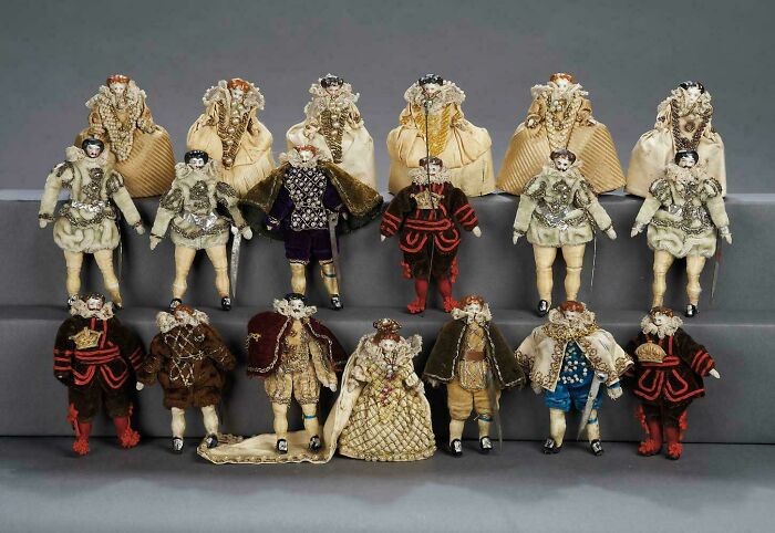Collection of miniature doll figures dressed in elaborate vintage costumes from strange discoveries