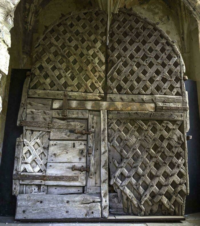 Old wooden lattice antique door with intricate weathered design from interesting artifacts