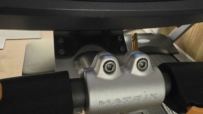 Exercise equipment bolts resembling eyes on metallic fitness machine