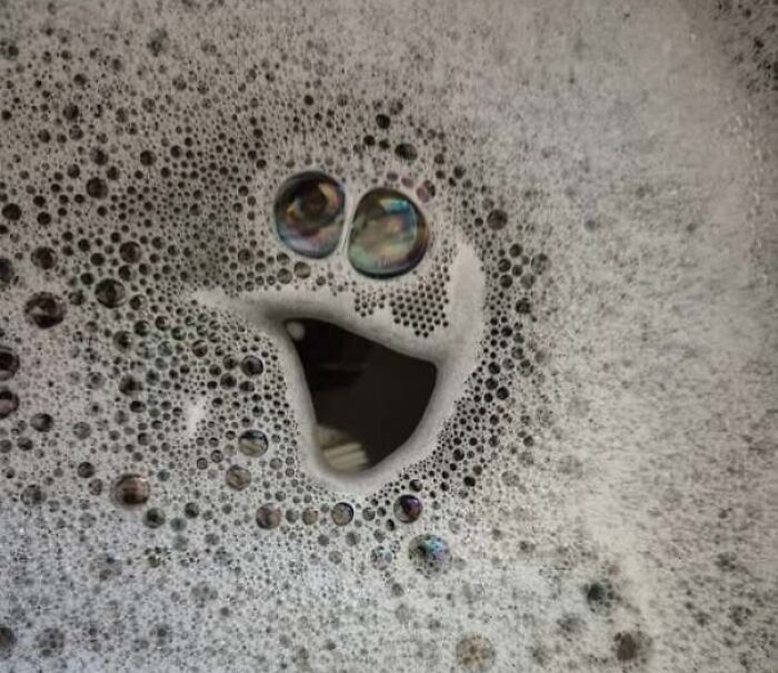 Soap bubbles forming a happy face in foam