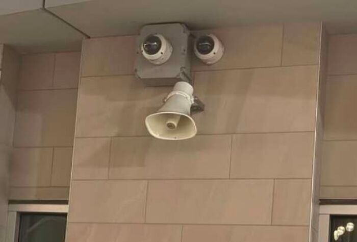 Wall security cameras and a speaker resembling a face