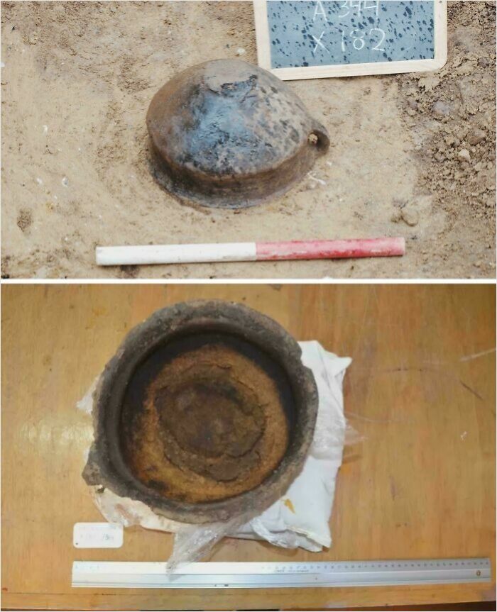 Archaeological discovery of ancient clay pot partially buried in soil