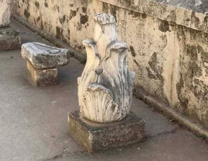 Carved stone sculpture shaped like a face with eyes and mouth