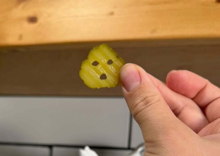 Pickle slice with seeds resembling a staring face