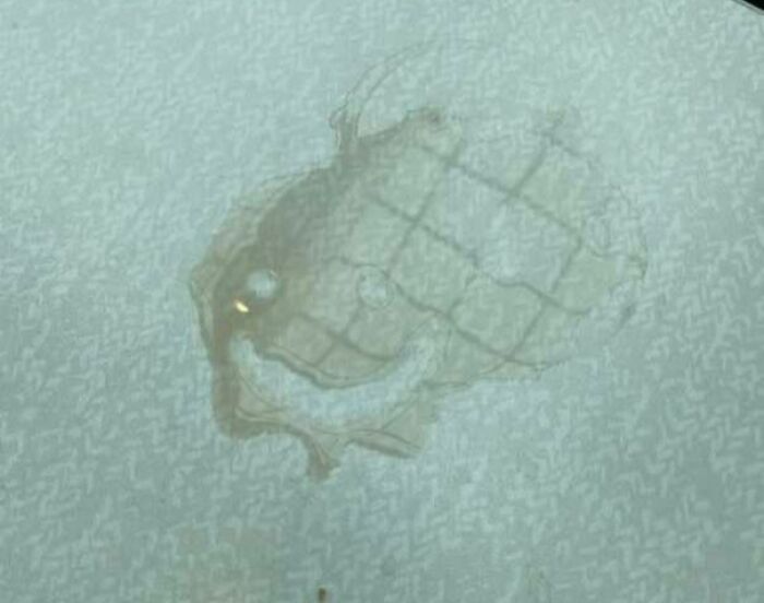Smudged pattern on glass resembling eyes and mouth staring