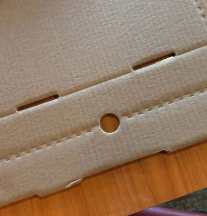 Cardboard with cutouts that look like a surprised face