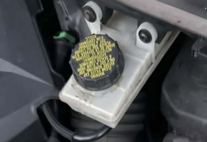 Car engine part resembling a face staring with two bolts like eyes
