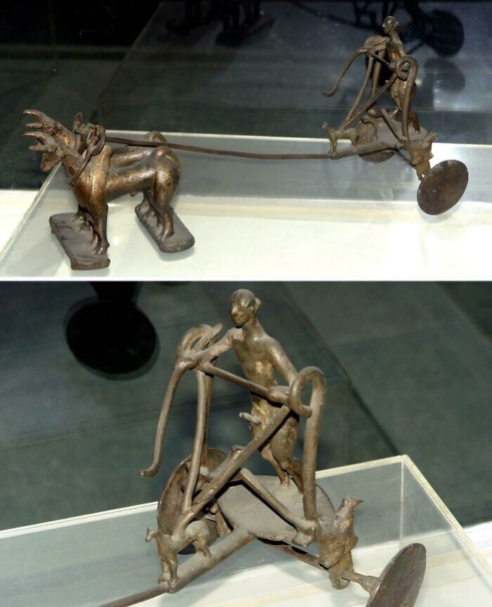 Ancient bronze chariot artifact with horse and driver sculpture discovery