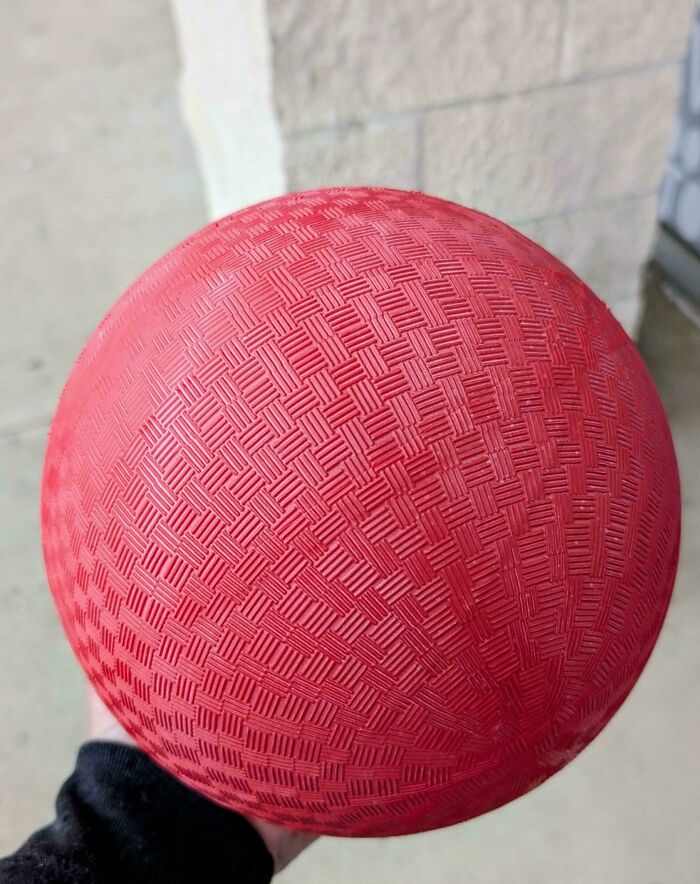 Classic red textured playground rubber ball close-up nostalgic toy