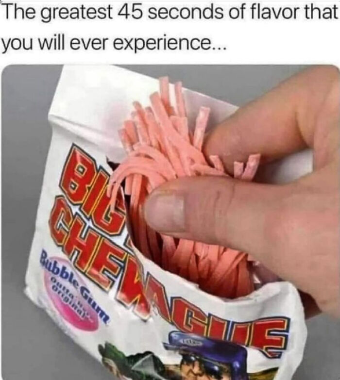 Hand pulling pink Big League chewing gum strands from original unopened packet