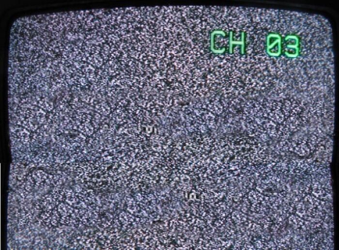Old TV screen showing static with green channel 3 indicator in corner