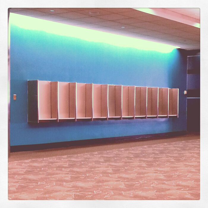 Rows of vintage wooden phone booths in hallway nostalgic scene