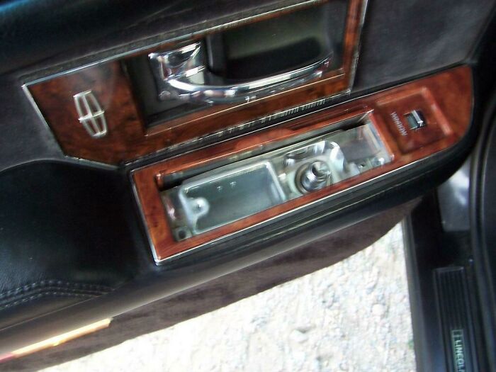 An old car door panel with a built-in cigarette lighter bringing back the good old days.