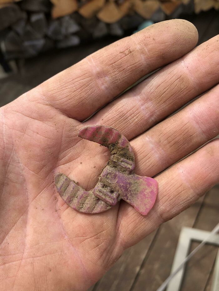 Old plastic toy piece found in hand evoking nostalgia