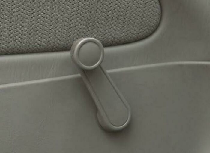 Vintage car manual window crank handle closeup