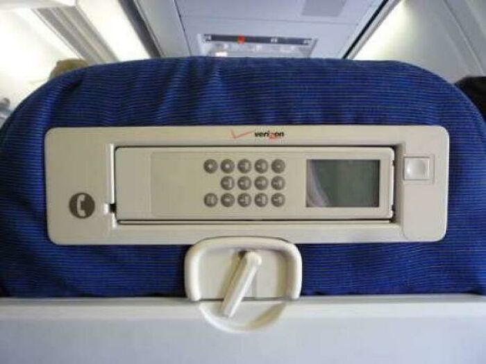 Nostalgic photo of airplane seatback with built-in telephone and screen