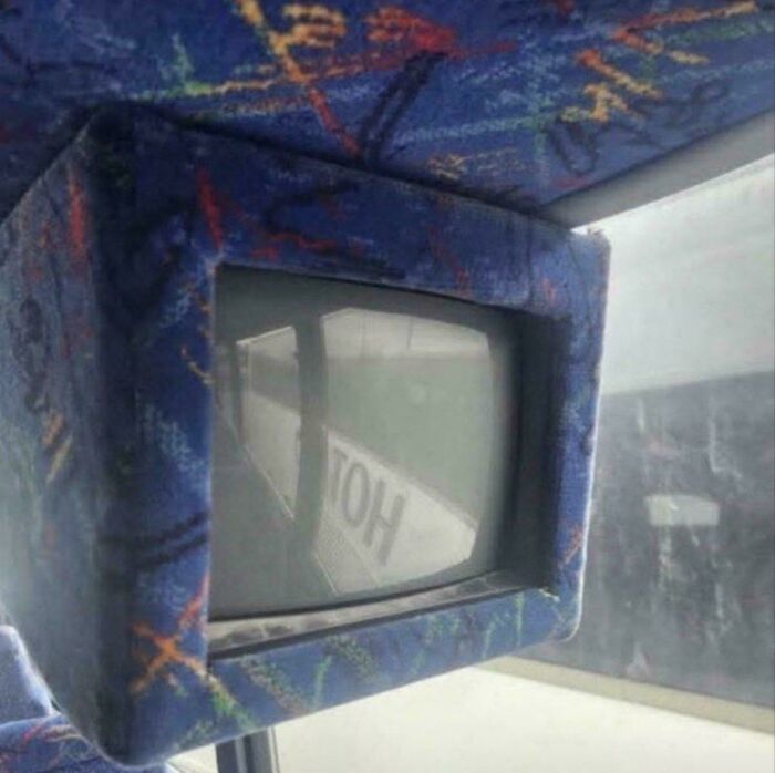 Nostalgic photo of old CRT TV inside patterned bus seat