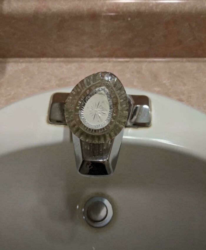 Nostalgic photo of vintage glass faucet handle on bathroom sink