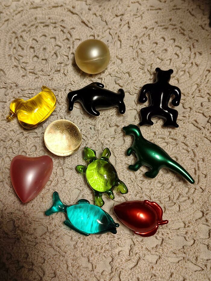 Collection of colorful classic plastic toy charms arranged on a beige fabric