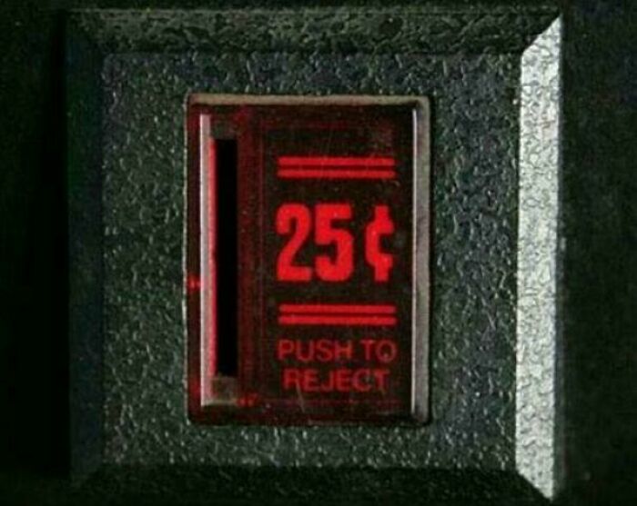 Close-up of a vending machine coin slot labeled 25 cents with push to reject