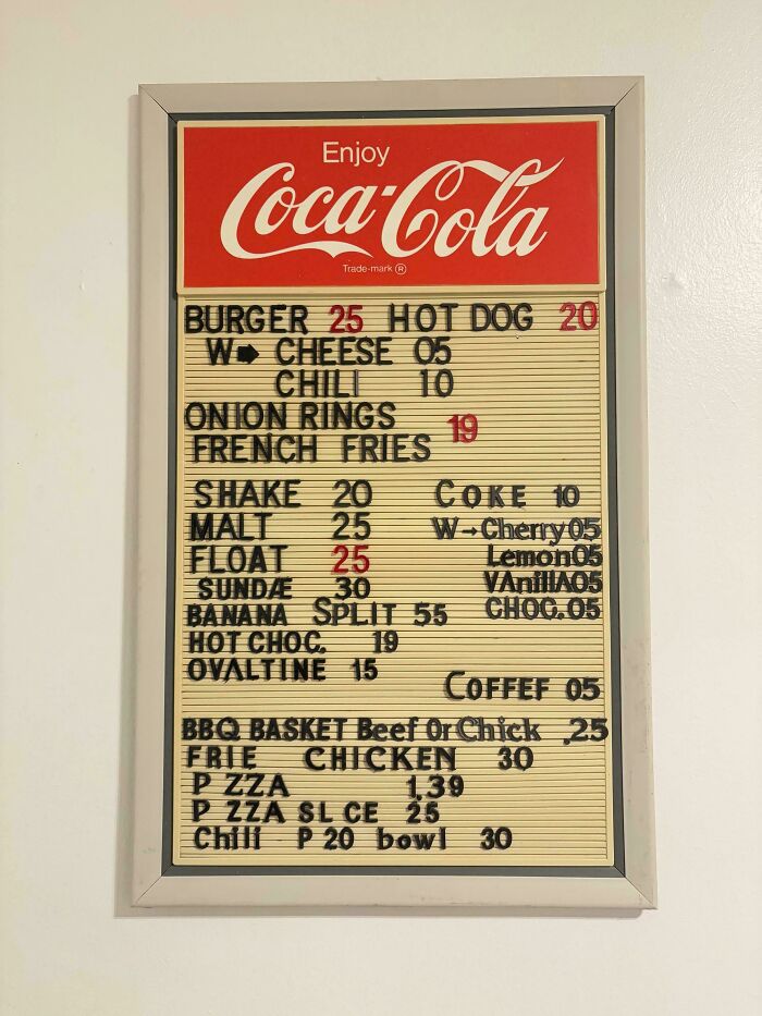 Retro Coca-Cola menu board showing prices of burgers, shakes, and fries