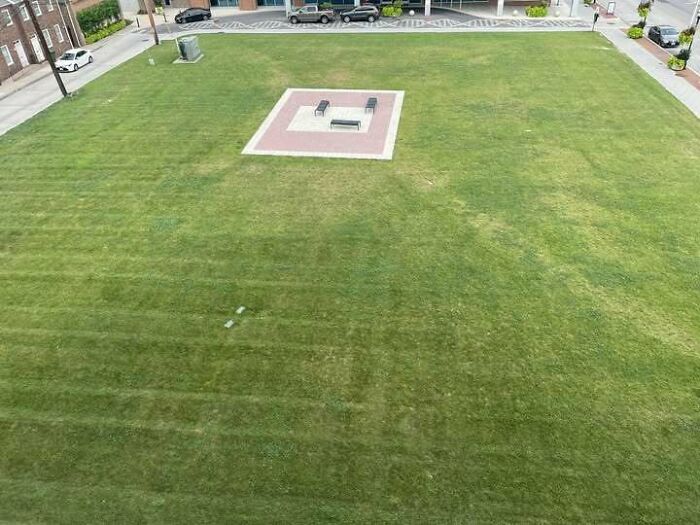 Construction fail showing a fire pit area with no pathway in a large grassy field