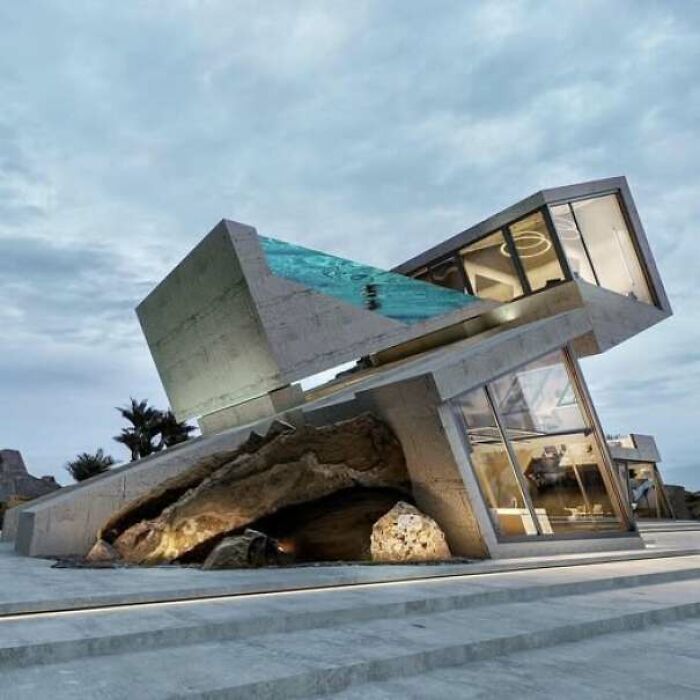 Modern house with tilted concrete structure and pool looking like a construction fail