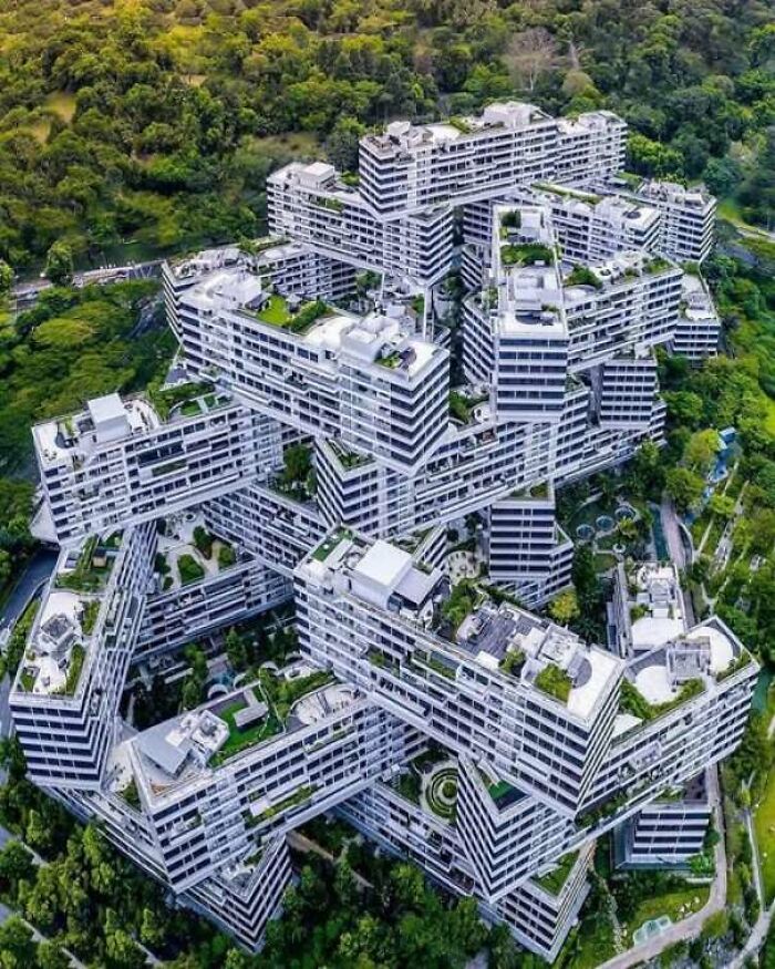 An aerial view of complex interlocking modern apartment buildings featuring unusual construction fails design