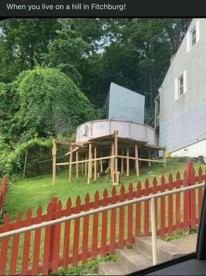 Unstable elevated structure on a hill supported by precarious wooden poles