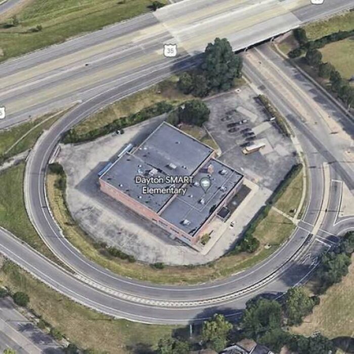 Aerial view of elementary school surrounded by a circular misbuilt road