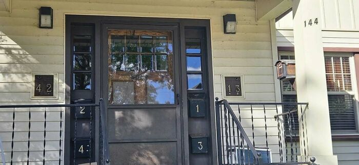 House entrance with mismatched house numbers creating a confusing display