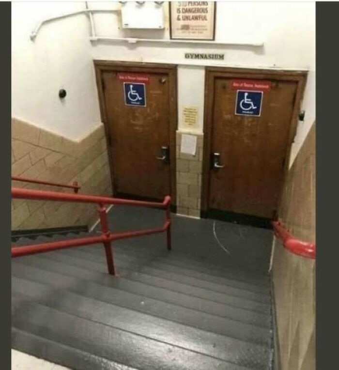 Staircase leading to two accessible gymnasium doors downhill, showing poor design
