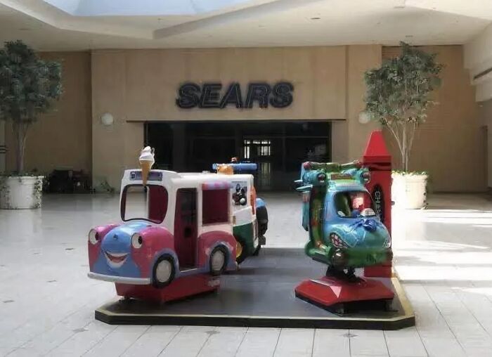 Vintage kids ride in a Sears mall play area evoking nostalgic memories
