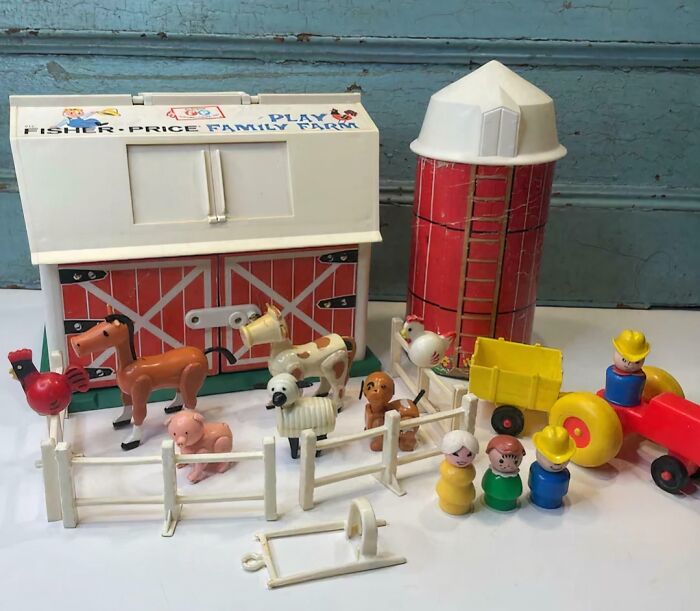 Vintage Fisher-Price Family Farm toy set with barn, silo, animals, and tractor