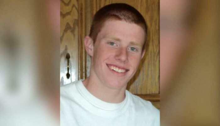 Portrait of a smiling young man in a white t-shirt, involved in creepy mysteries.