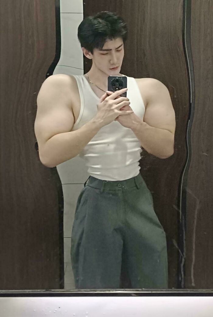 Ridiculously edited photo of man with extremely enlarged arms and shoulders