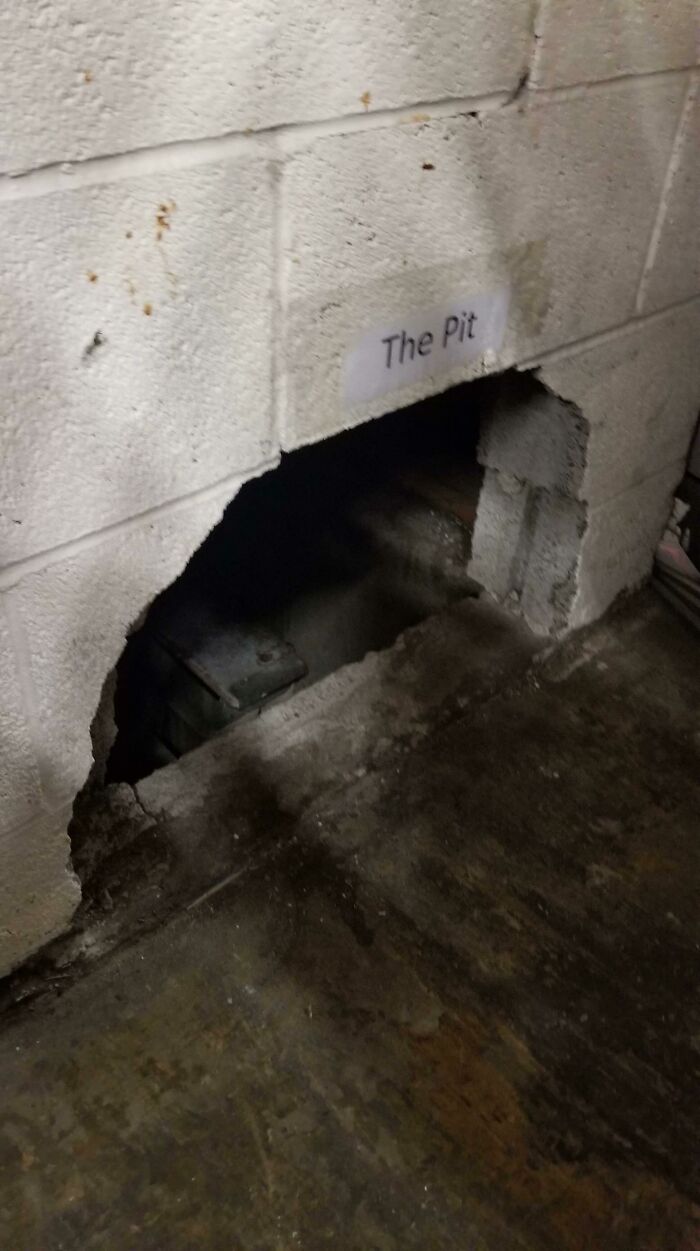A dark, mysterious opening in a cinder block wall labeled The Pit, adding to cursed images.