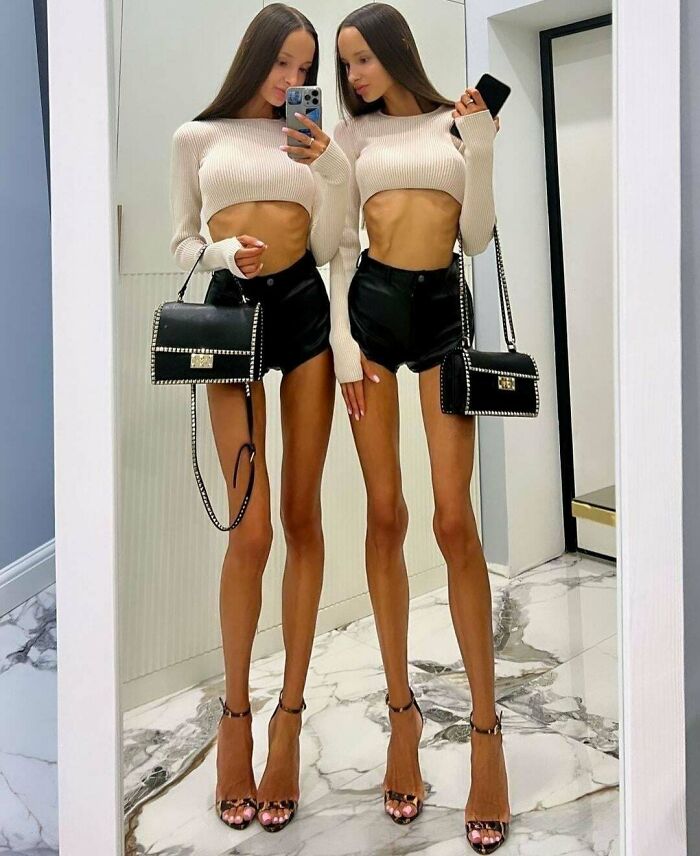 Ridiculously edited photo of twin women with extremely elongated skinny legs