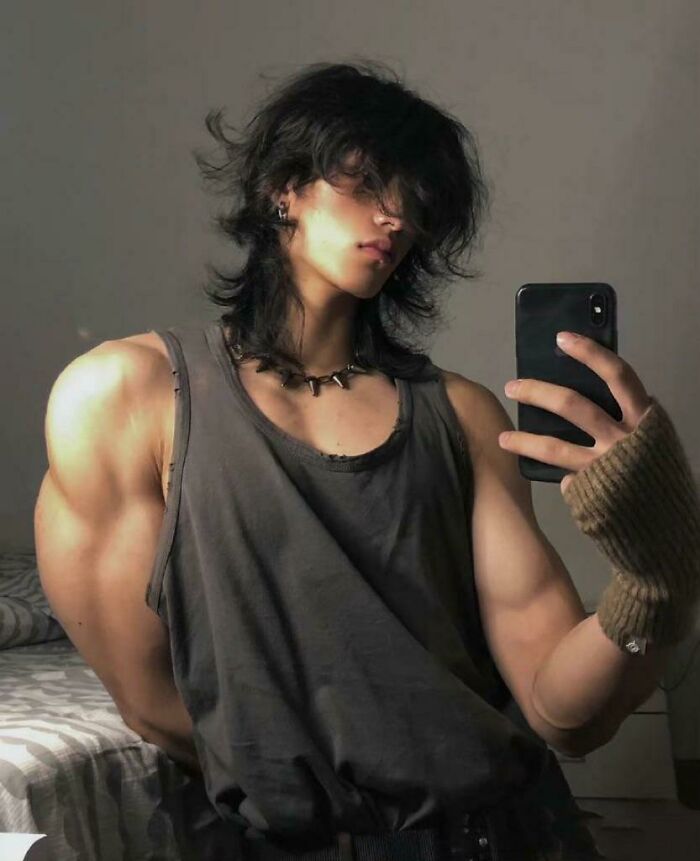 Selfie showing edited photo with unproportionally huge muscular arms