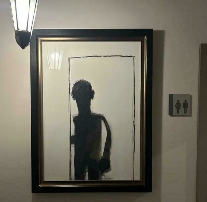 Eerie painting of a dark shadowy figure hanging outside a restroom door, fitting cursed images theme.