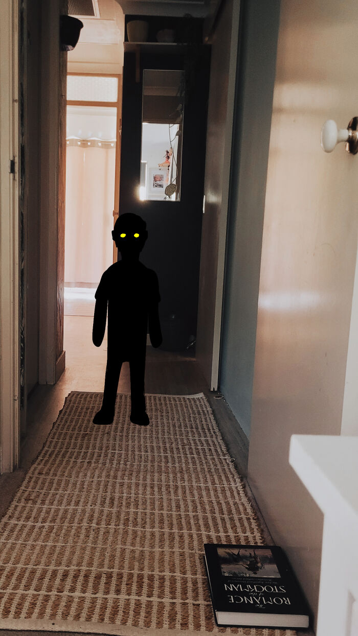 Creepy photos showing a shadowy dark figure with glowing yellow eyes standing in a narrow hallway.