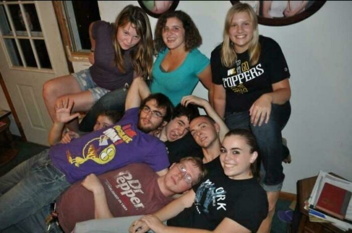 A group pose turns into creepy photos as an extra face peeks from behind a door window