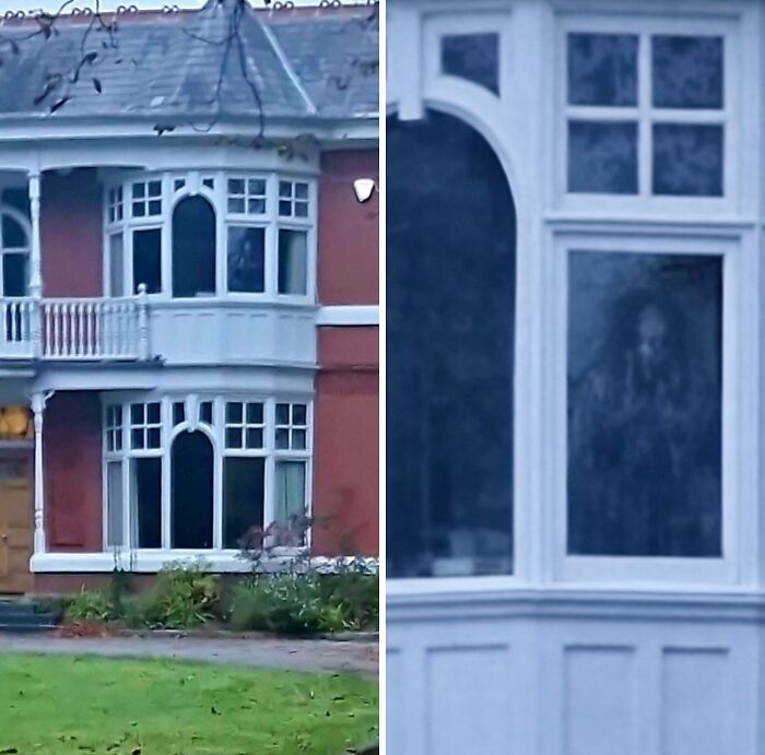 Ghostly spectral figure appearing in window of house featured in creepy photos.