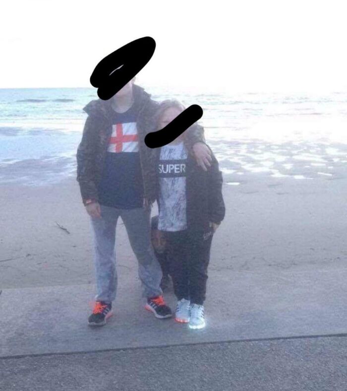 A photo of two people on a beach with hidden details that belong in creepy photos and stories.
