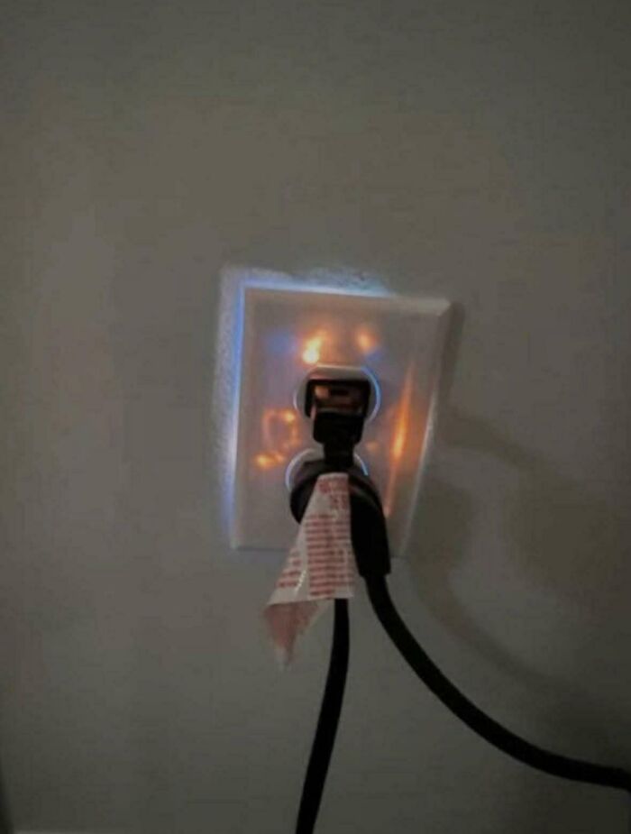 An electrical outlet dangerously glowing from inside in a collection of cursed images.