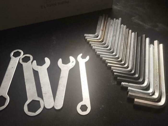 A collection of flat wrenches and Allen keys neatly arranged on a table for home DIY projects by a dad.