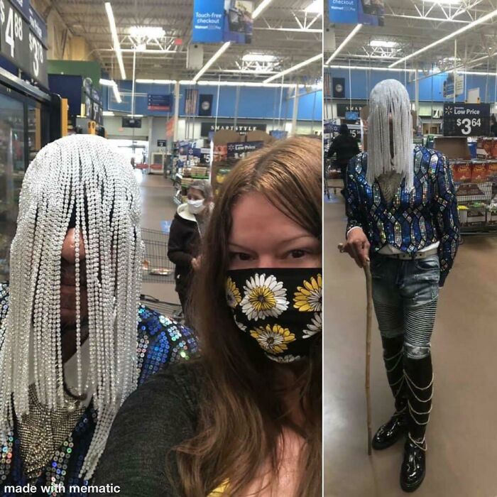 Person with beaded headpiece and sequined jacket with another person wearing daisy mask inside Walmart store