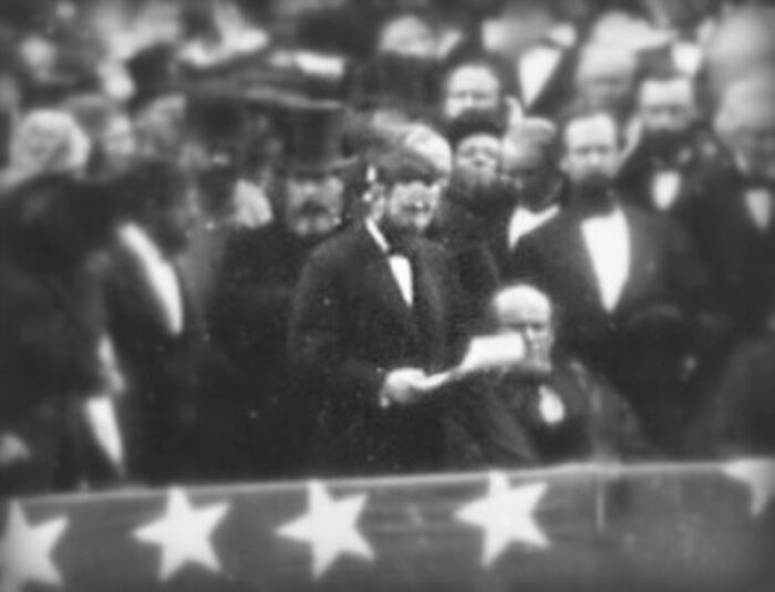 Rare historical photo showing a speech at a formal event with a crowd