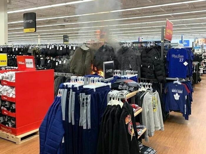 Clothing display with jackets and pants inside Walmart store